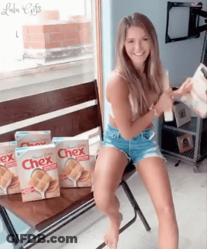 Woman Sitting On Bench Next To Boxes Of Chex GIF