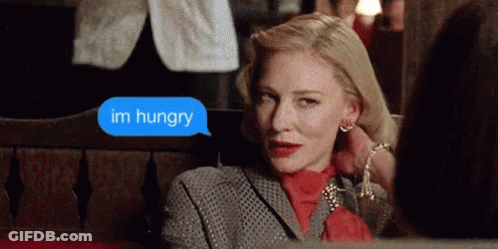 Woman Sitting On Bench Says Im Hungry GIF