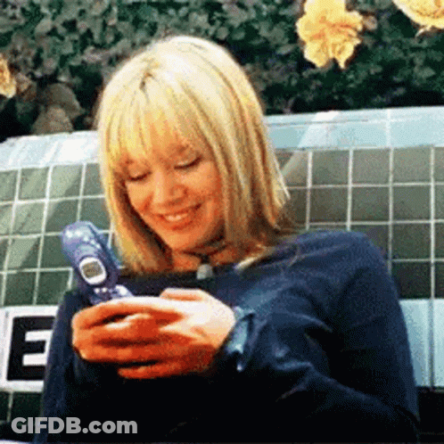Woman Sitting On Bench Using Cell Phone GIF