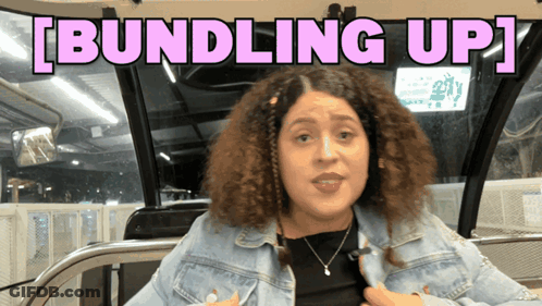 Woman Sitting On Bus Saying Bundling Up GIF