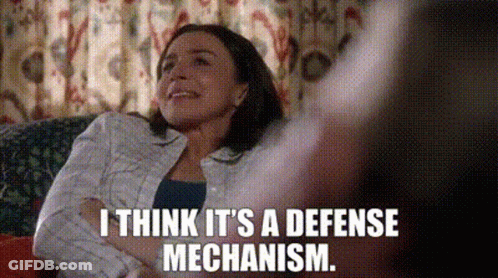 Woman Sitting On Couch Arms Crossed Smiling GIF