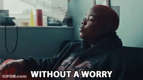 Woman Sitting On Couch Eyes Closed Without A Worry GIF