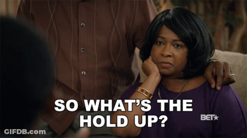 Woman Sitting On Couch Hand On Chin Saying So What's The Hold Up GIF