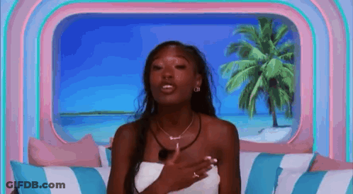 Woman Sitting On Couch Hands On Chest Ocean View GIF