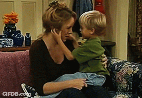 Woman Sitting On Couch Holding Child GIF