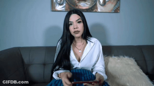 Woman Sitting On Couch Holding Red Remote GIF