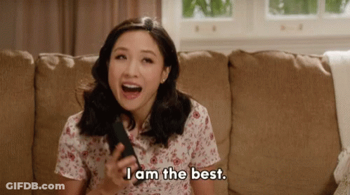 Woman Sitting On Couch Holding Remote Saying I Am The Best GIF