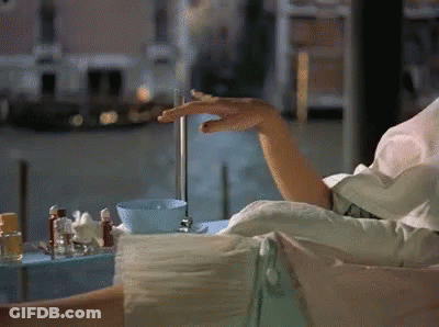 Woman Sitting On Couch Holding Water GIF