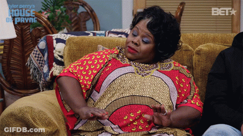 Woman Sitting On Couch House Of Payne Sign GIF