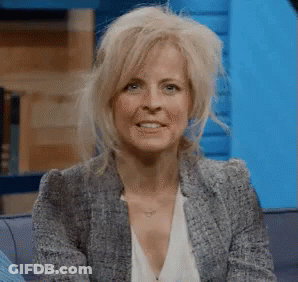 Woman Sitting On Couch In Blazer And White Shirt GIF