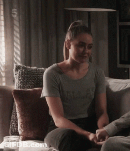Woman Sitting On Couch In Dallas Shirt GIF