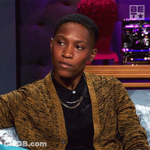 Woman Sitting On Couch In Front Of Be On It Sign GIF