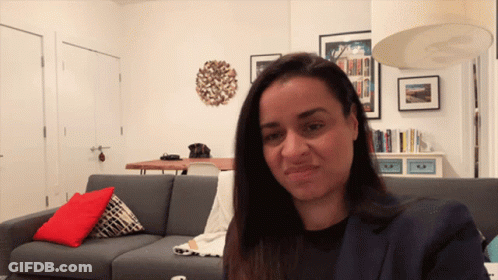 Woman Sitting On Couch In Living Room GIF