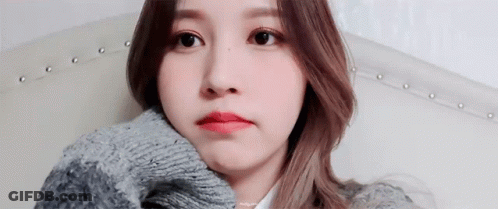 Woman Sitting On Couch In Sweater GIF