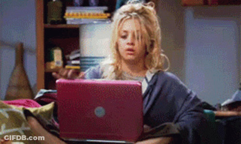 Woman Sitting On Couch Looking At Laptop GIF
