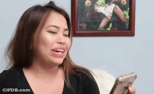 Woman Sitting On Couch Looking At Phone GIF