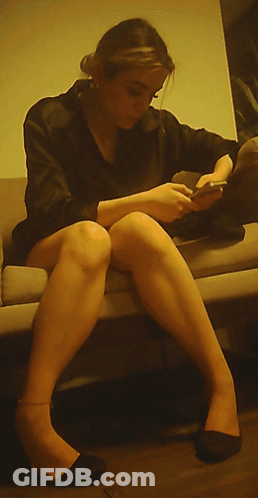 Woman Sitting On Couch Looking At Phone GIF