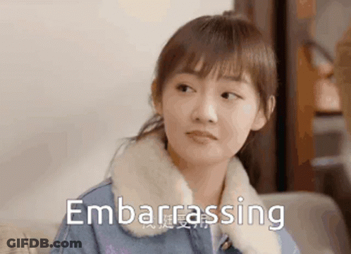 Woman Sitting On Couch Making Embarrassed Face GIF