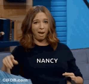 Woman Sitting On Couch Making Funny Face GIF
