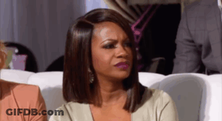 Woman Sitting On Couch Making Funny Face GIF