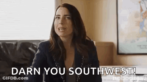 Woman Sitting On Couch Making Funny Face GIF