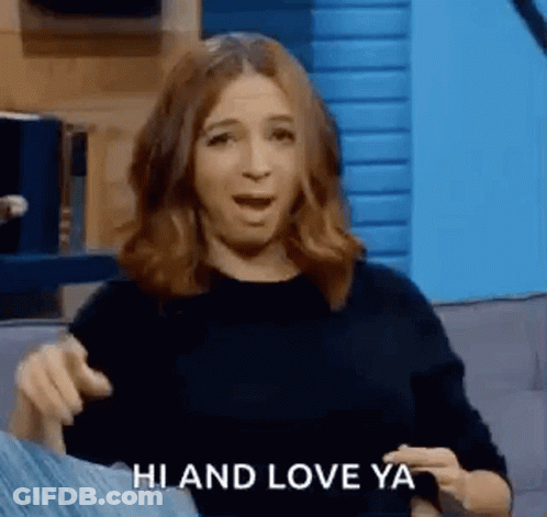 Woman Sitting On Couch Making Funny Face Saying Hi And Love Ya GIF