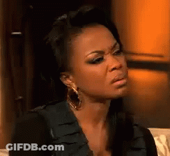 Woman Sitting On Couch Making Funny Face GIF