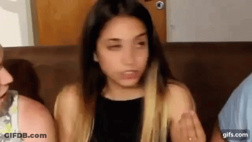 Woman Sitting On Couch Making Funny Face GIF