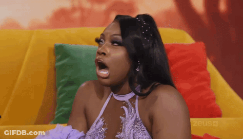 Woman Sitting On Couch Mouth Open GIF