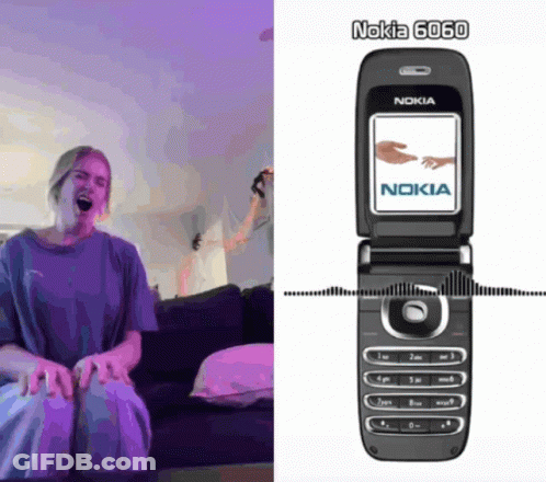 Woman Sitting On Couch Next To Nokia Phone GIF