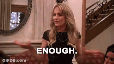 Woman Sitting On Couch Saying Enough With Arms Outstretched GIF