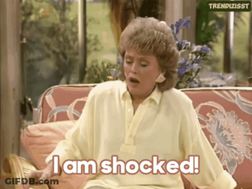 Woman Sitting On Couch Saying I Am Shocked GIF
