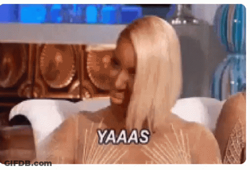 Woman Sitting On Couch Saying Yaaas GIF