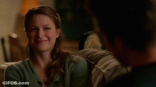Woman Sitting On Couch Smiling At Man GIF