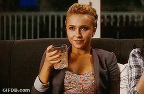 Woman Sitting On Couch Smiling Holding Glass Of Water GIF