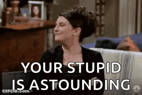 Woman Sitting On Couch Smiling Your Stupid Is Astounding GIF