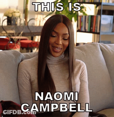 Woman Sitting On Couch This Is Naomi Campbell GIF