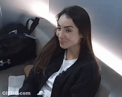 Woman Sitting On Couch With Black Under Armour Bag GIF