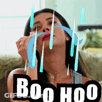 Woman Sitting On Couch With Boo Hoo Sign GIF