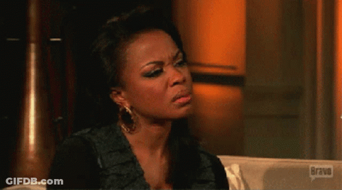 Woman Sitting On Couch With Bravo Logo GIF