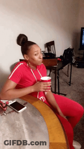 Woman Sitting On Couch With Coffee GIF