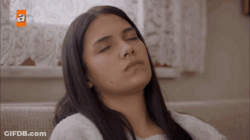 Woman Sitting On Couch With Eyes Closed GIF