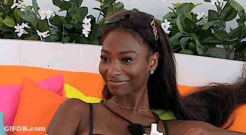 Woman Sitting On Couch With Flowers GIF