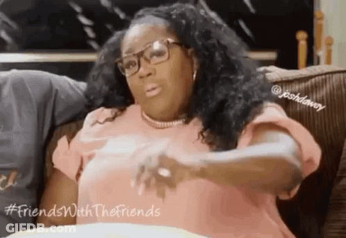 Woman Sitting On Couch With Glasses And Necklace GIF