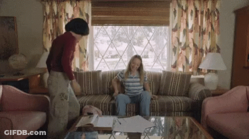 Woman Sitting On Couch With Man Standing Behind GIF