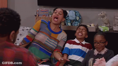 Woman Sitting On Couch With Mouth Open Surrounded By Children GIF