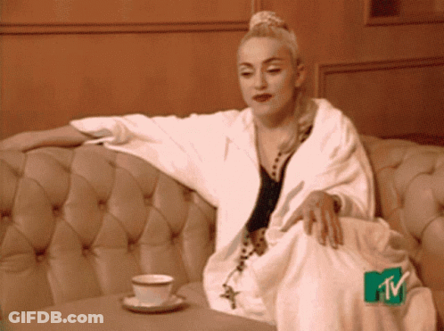 Woman Sitting On Couch With MTV Logo On Feet GIF