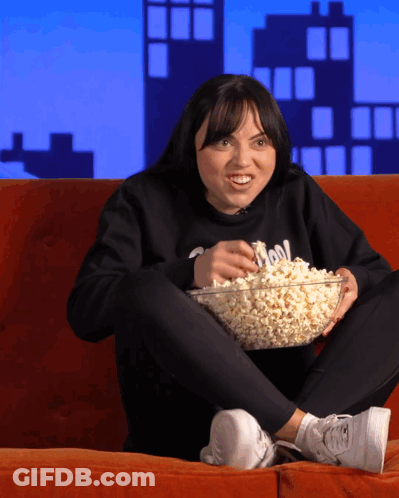 Woman Sitting On Couch With Popcorn GIF