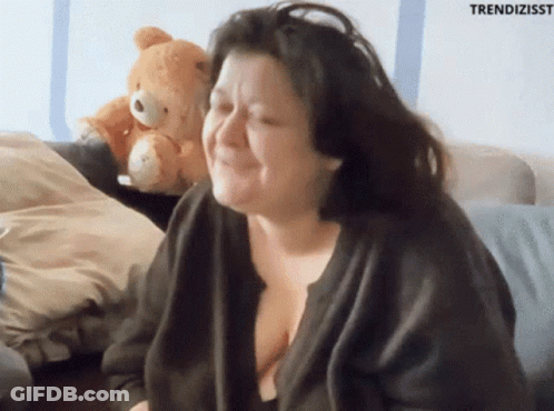 Woman Sitting On Couch With Teddy Bear And Trendizisst GIF