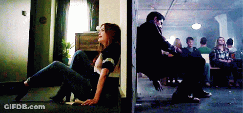 Woman Sitting On Floor Next To Man In Chair GIF